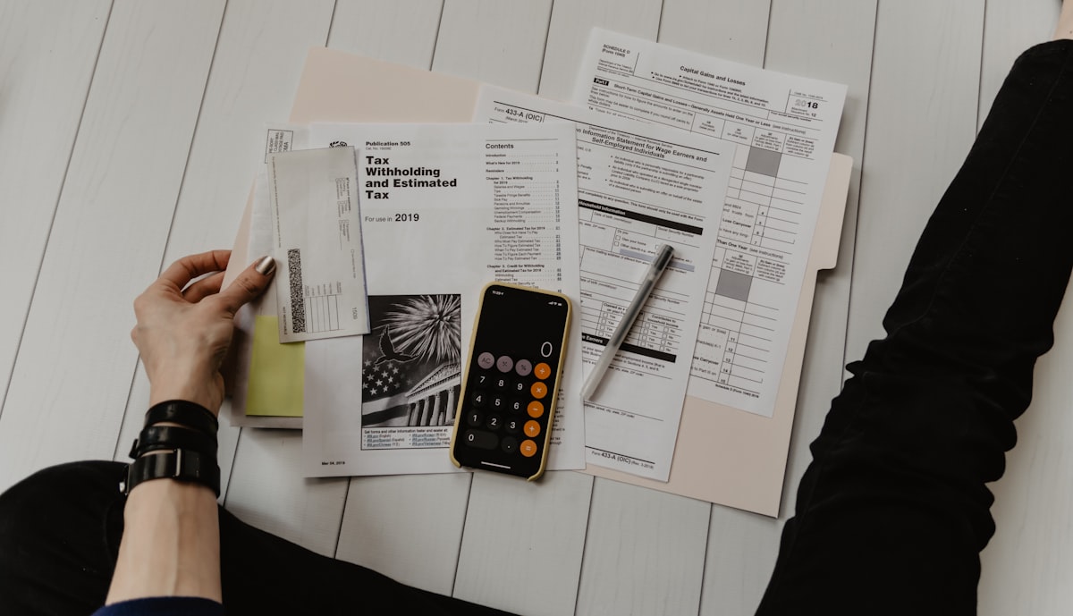 Tax documents and calculator on a desk, representing accounting services
